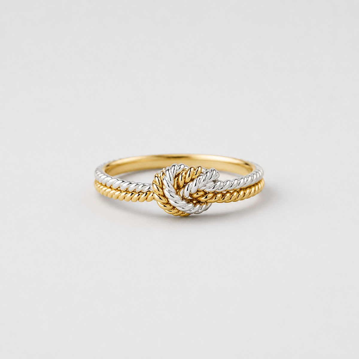 Two Tone Love Knot Ring on light gray studio background
