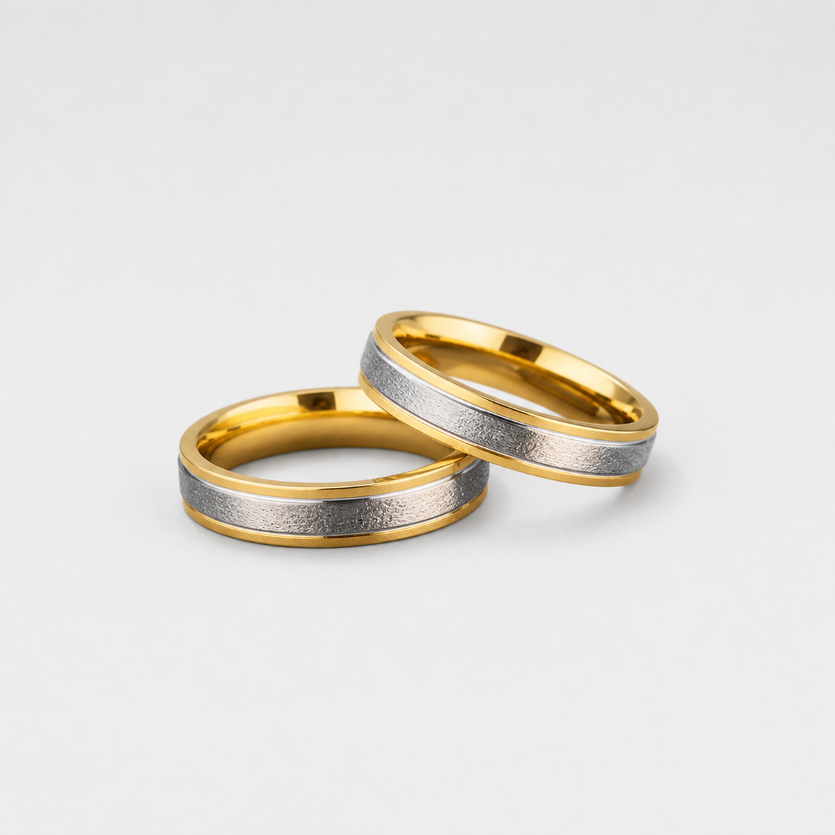 Two Tone Brushed Gold Bands on light gray studio background