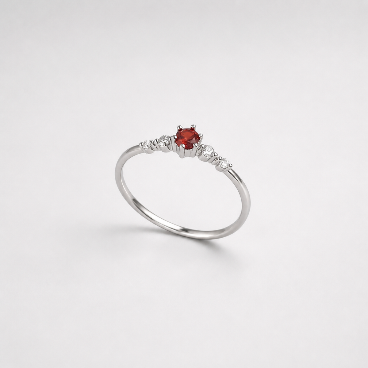 Petite Ruby Crystal Promise Ring on light gray studio background
