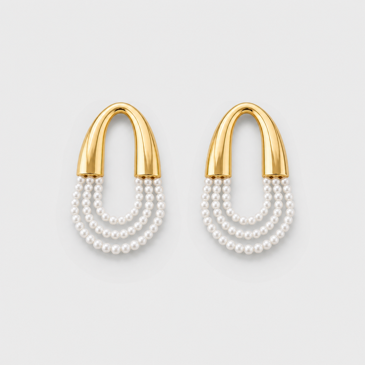 Pearl Draped U Link Drop Earrings left and right pair on light gray background