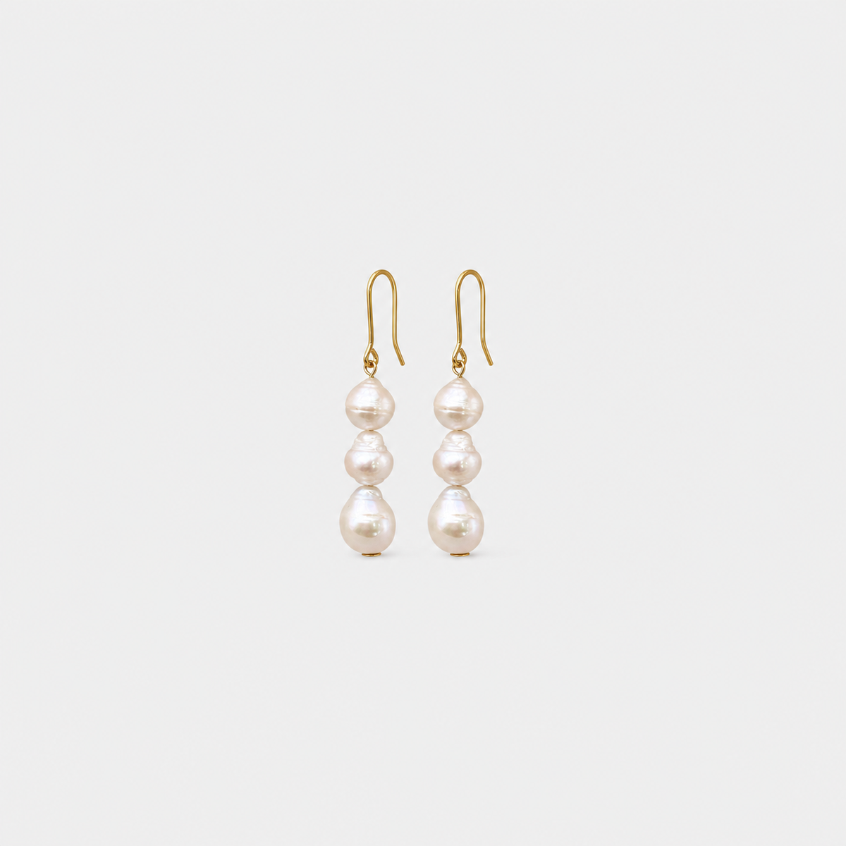 Triple Drop Baroque Pearl Earrings left and right pair on light gray background