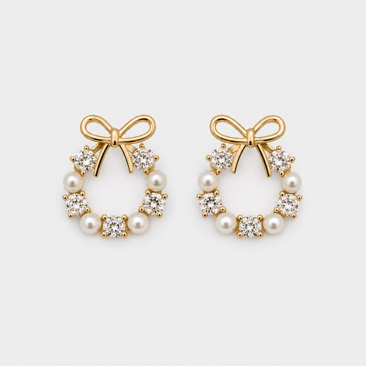 Bow Halo Pearl Stud Earrings left and right pair on light gray background