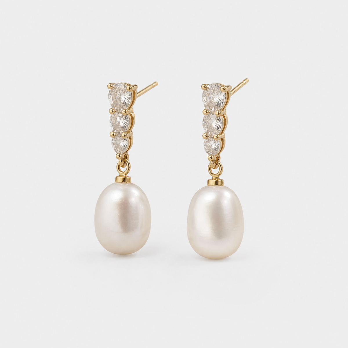 Pearl Drop Trio Sparkle Studs left and right pair on light gray background