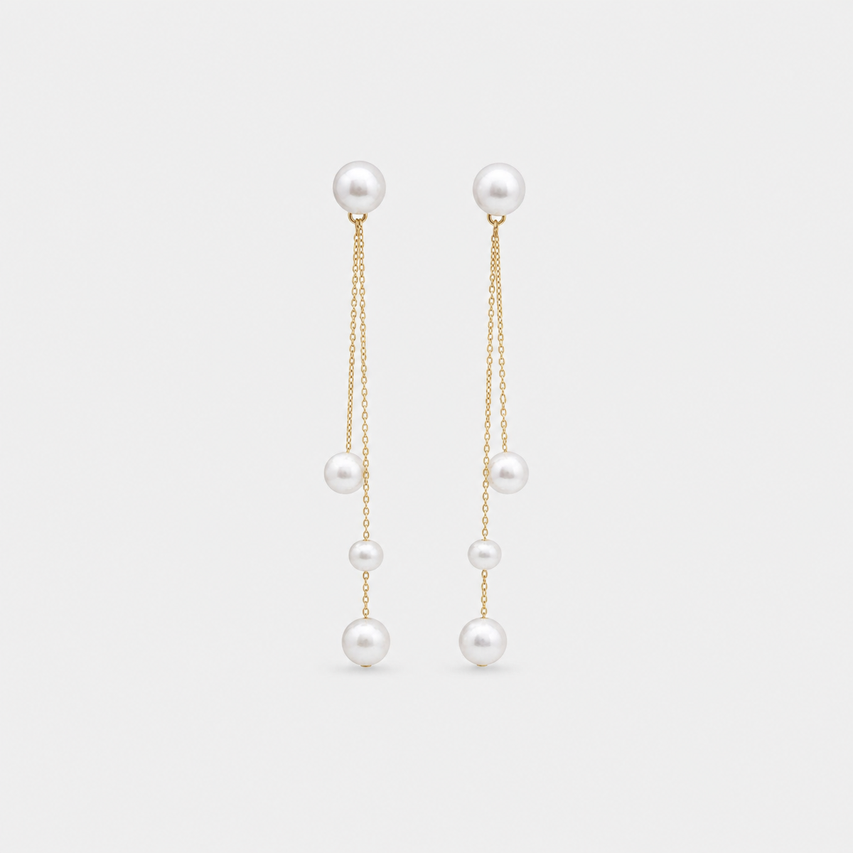 Pearl Chain Trio Drop Earrings left and right pair on light gray background