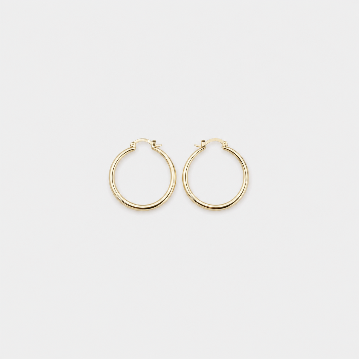 Bold Gold Hoop Earrings left and right pair on light gray background