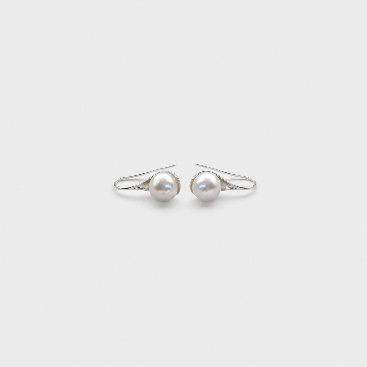 Vintage Pearl Drop Earrings — left and right pair on light gray background