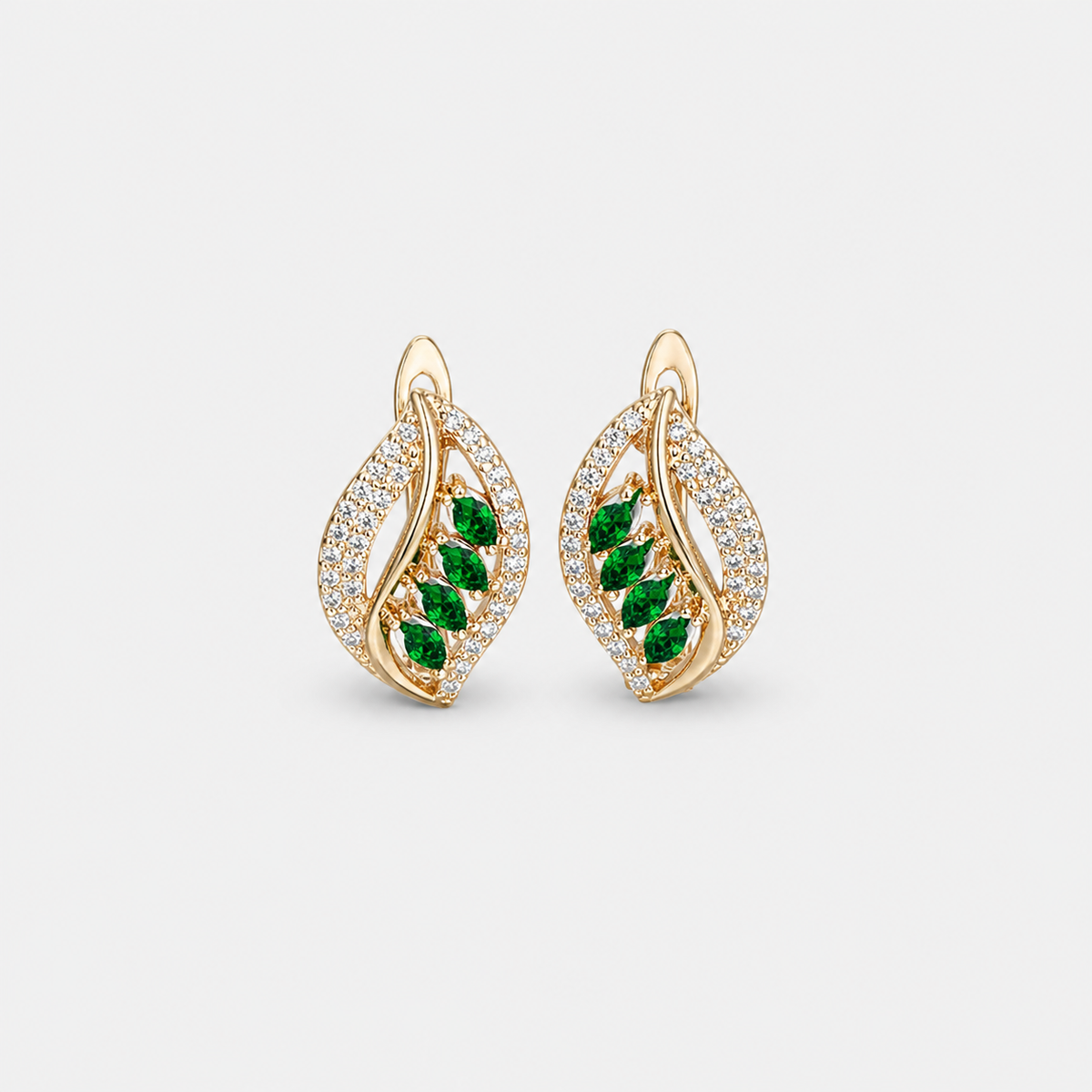 Sparkling Leaf Emerald Crystal Earrings — left and right pair on light gray background
