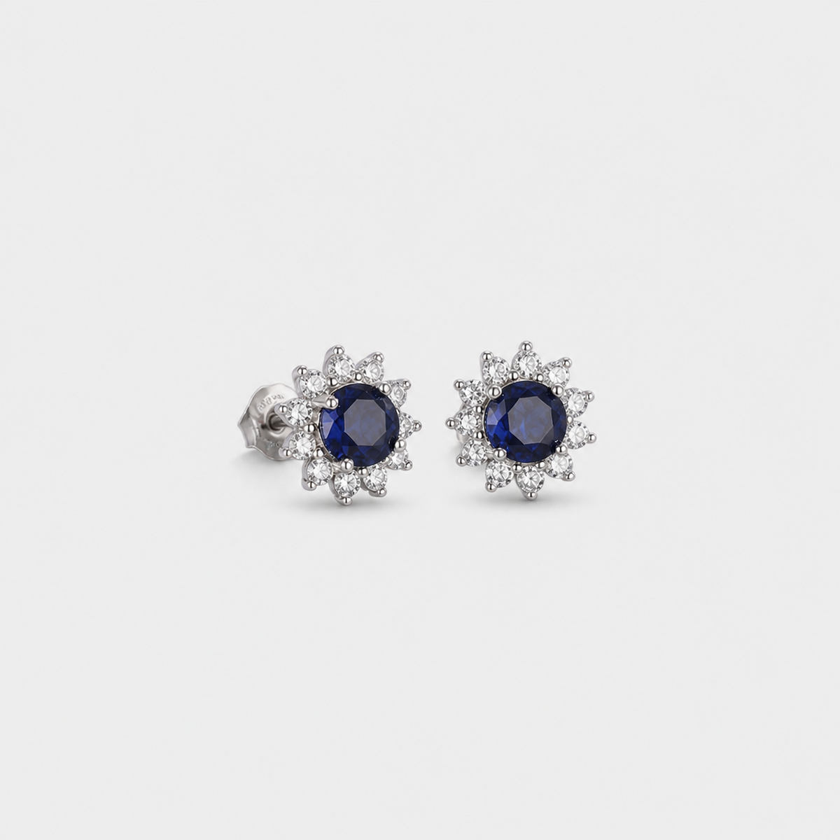 Sapphire Celestial Bloom Earrings — left and right pair on light gray background