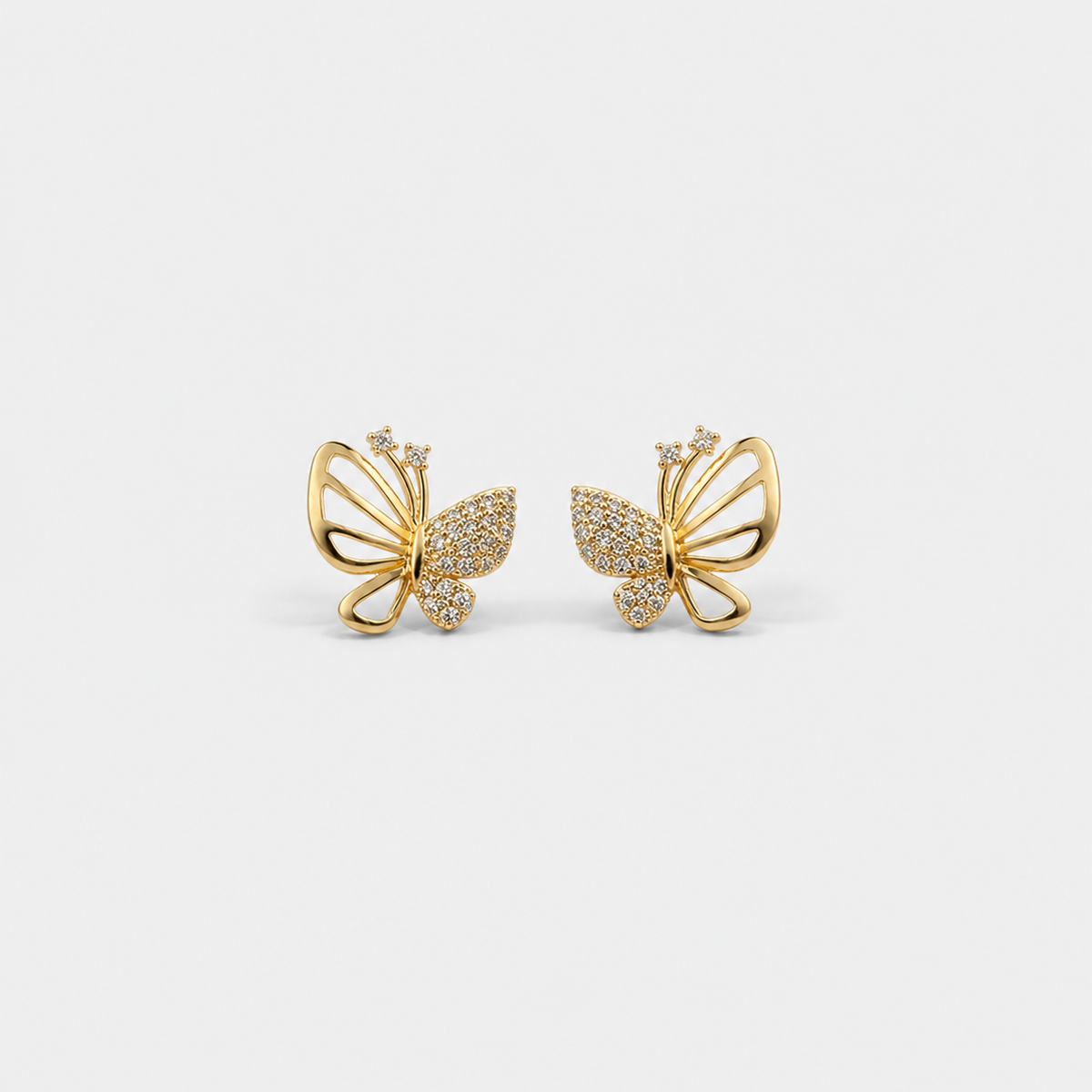 Butterfly Pavé Gold Stud Earrings — left and right pair on light gray background