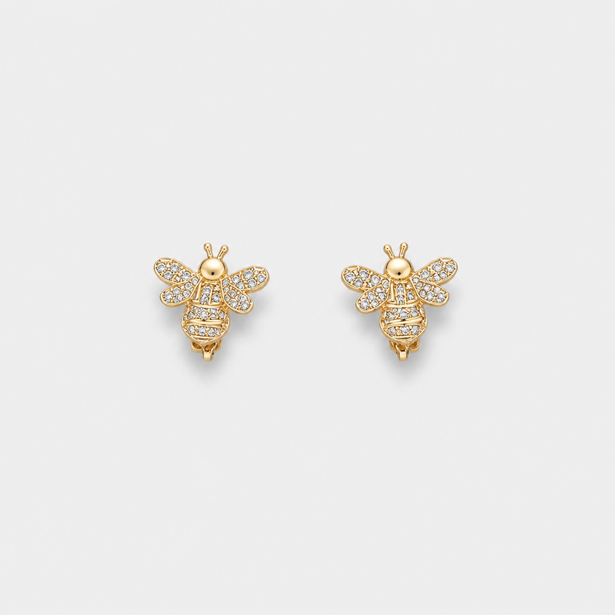 Gold One Piece Bee Earrings — left and right pair on light gray background