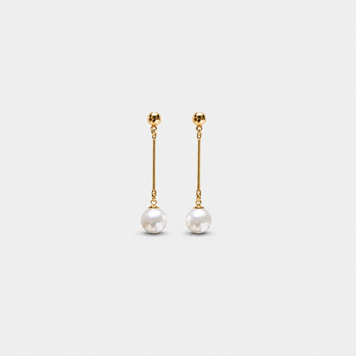 Luxury Dangling Earrings with Hand-Plaid Pearls — left and right pair on light gray background
