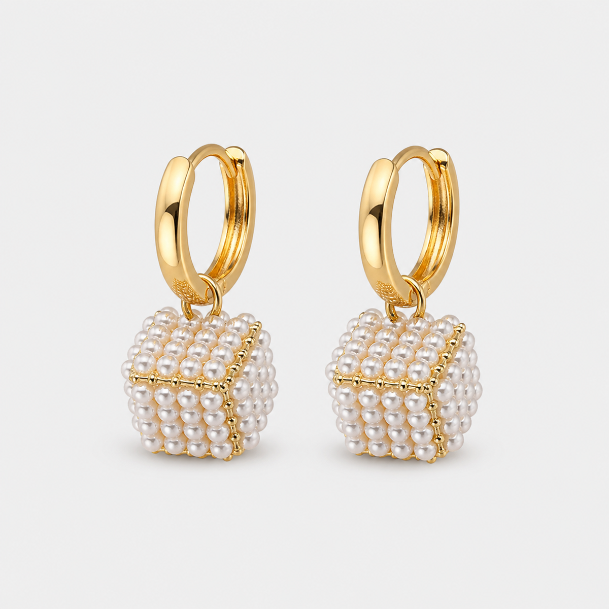 Elegant Cubic Pearl Earrings — left and right pair on light gray background