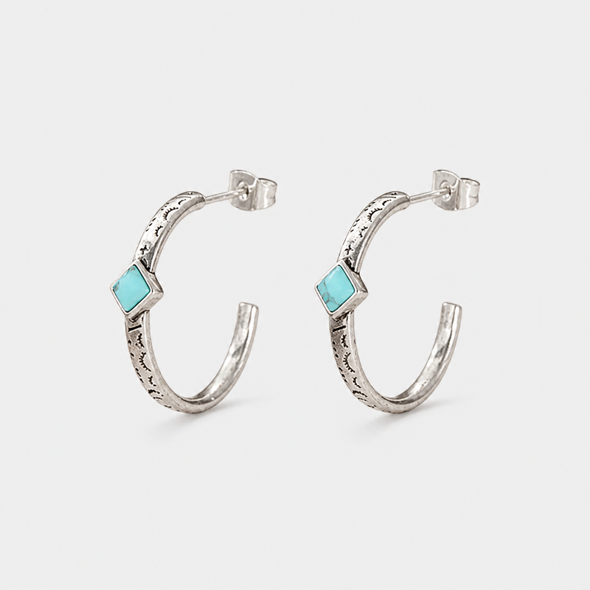 Bohemian Hand Carved Hoop Earrings — left and right pair on light gray background