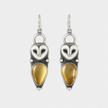 Vintage Silver Owl Drop Earrings — left and right pair on light gray background