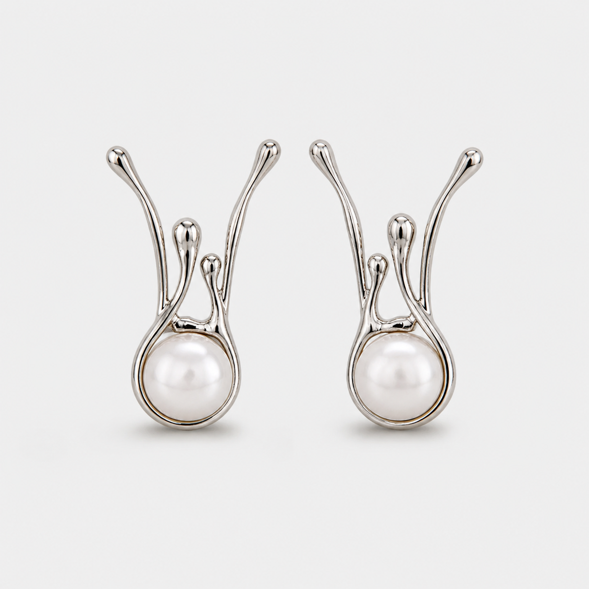 Antique Irregular Silver Pearl Earrings — left and right pair on light gray background