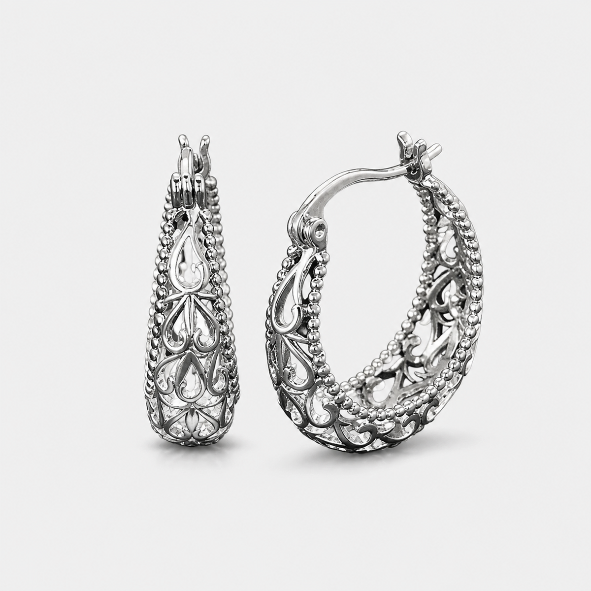 Antique Hollow Basket Earrings — left and right pair on light gray background
