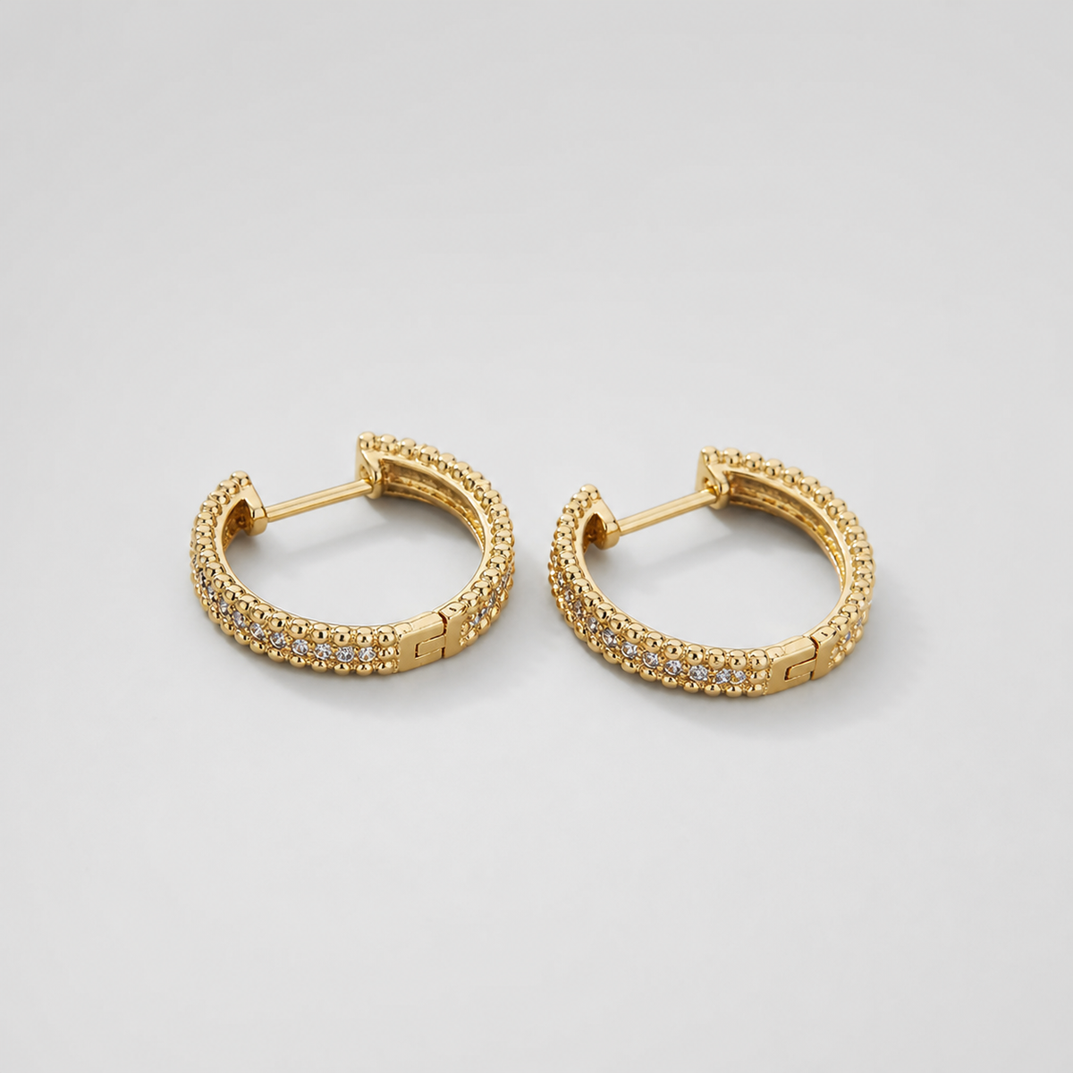 Studded Crystal Hoop Earrings pair on light gray background