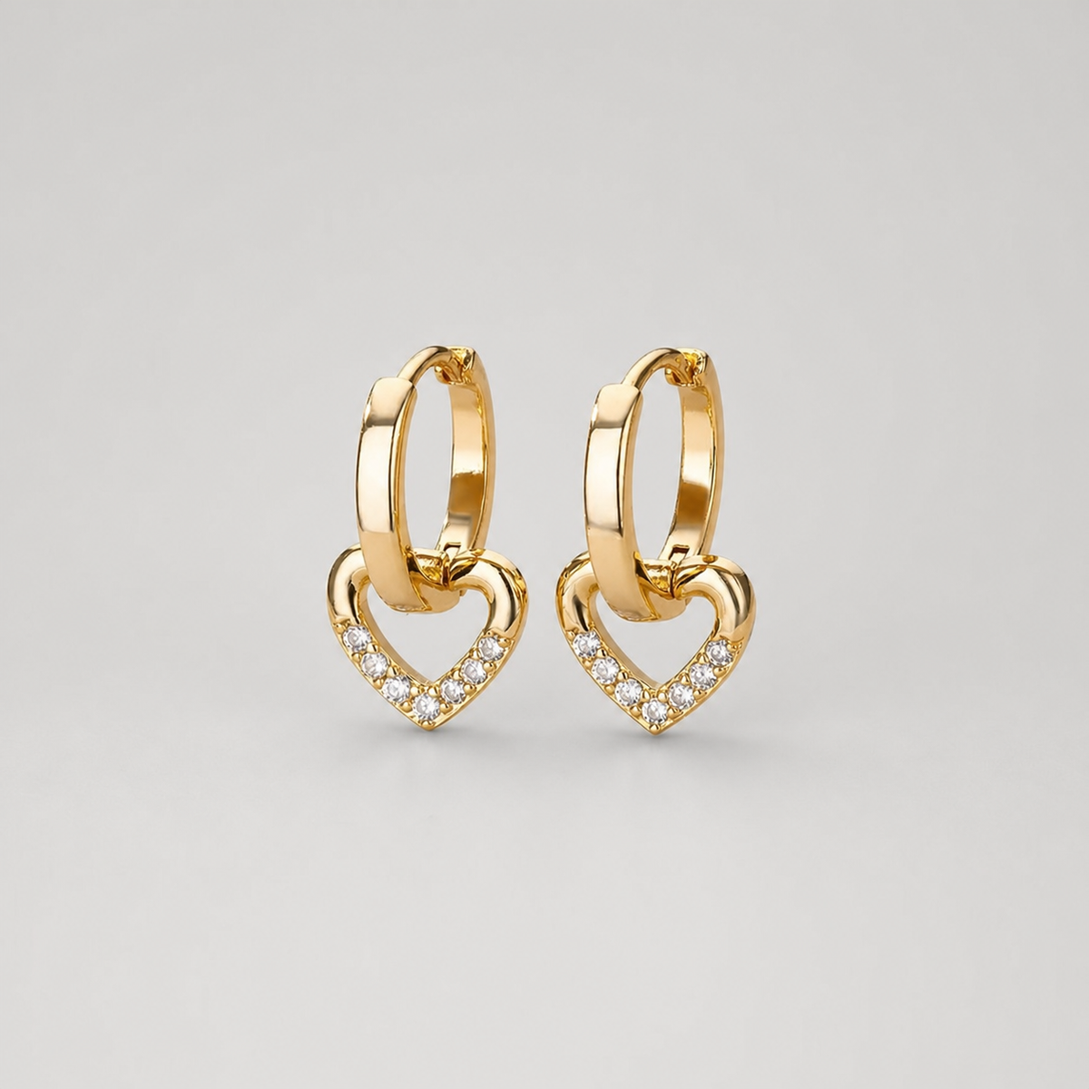 Hollow Zirconia Heart Earrings pair on light gray background