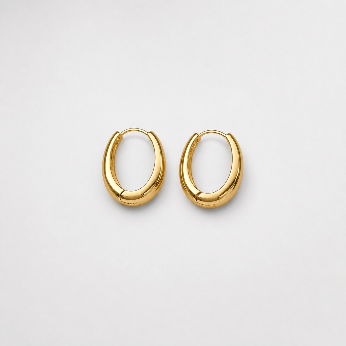 Classic Golden Hoop Earrings pair on light gray background