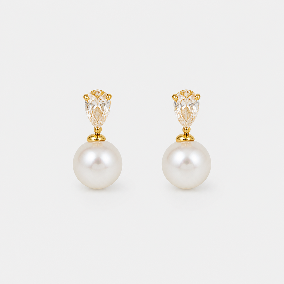 Classic Pearl Teardrop Stud Earrings – pair on light gray background