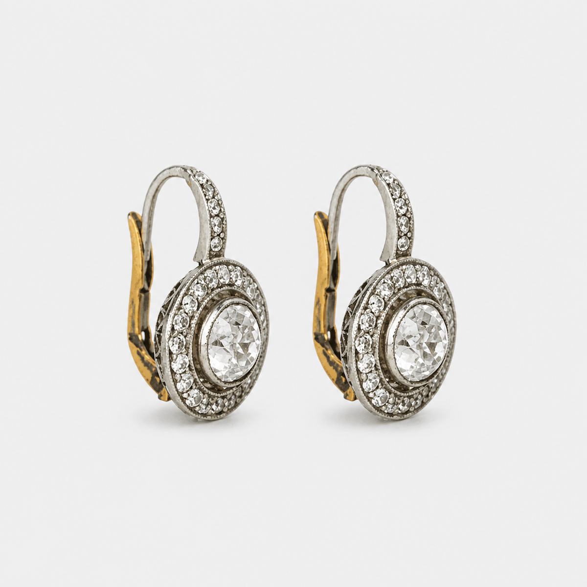 Vintage Gold and Silver Crystal Earrings – pair on light gray background