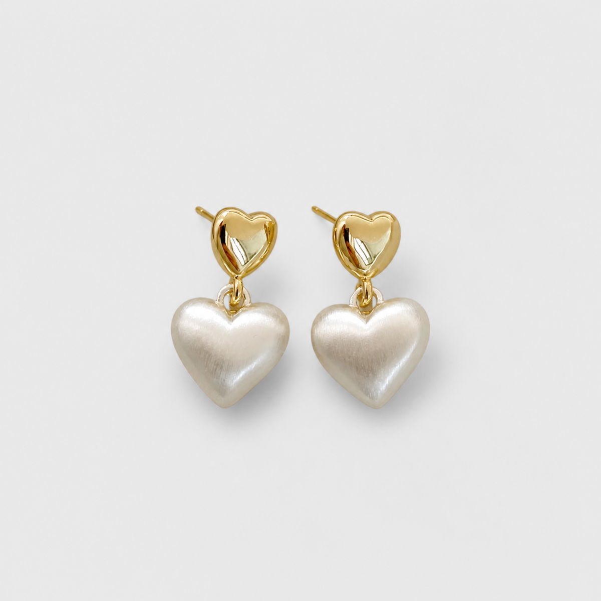 Elegant Gold Pearl Heart Earrings left and right pair on light gray background