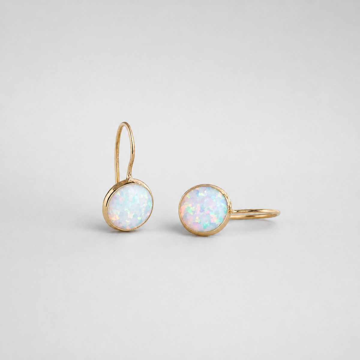 White Opal Vintage Earrings left and right pair on light gray background
