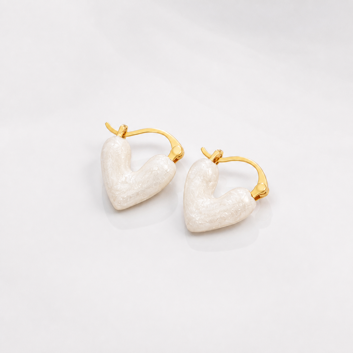 Pure White Heart Earrings on white studio background